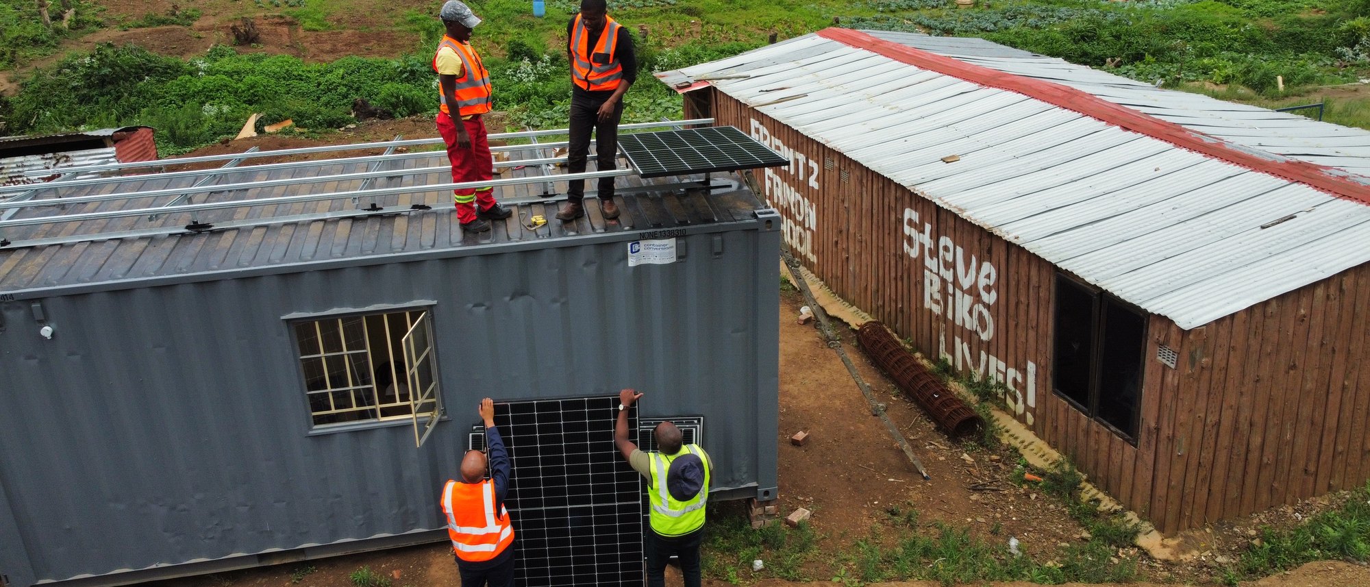Aerial view of solar panels installed on township rooftops