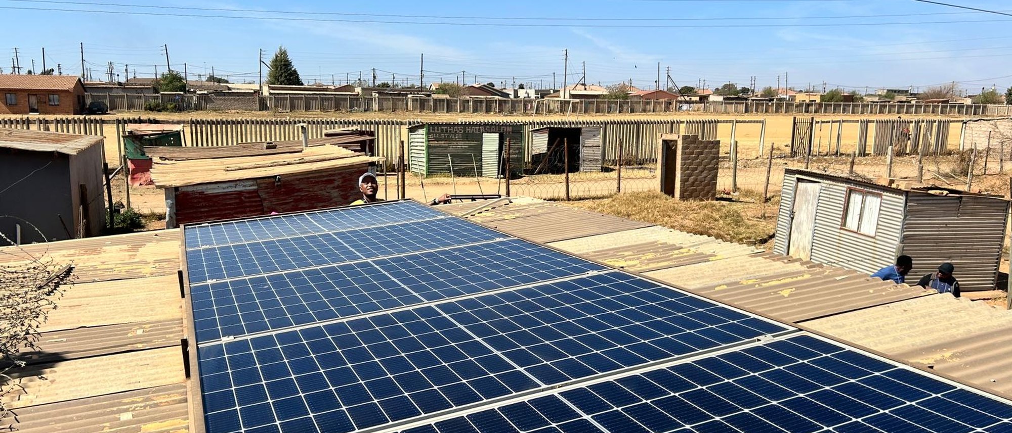 Rooftop solar panel installation in a South African township community